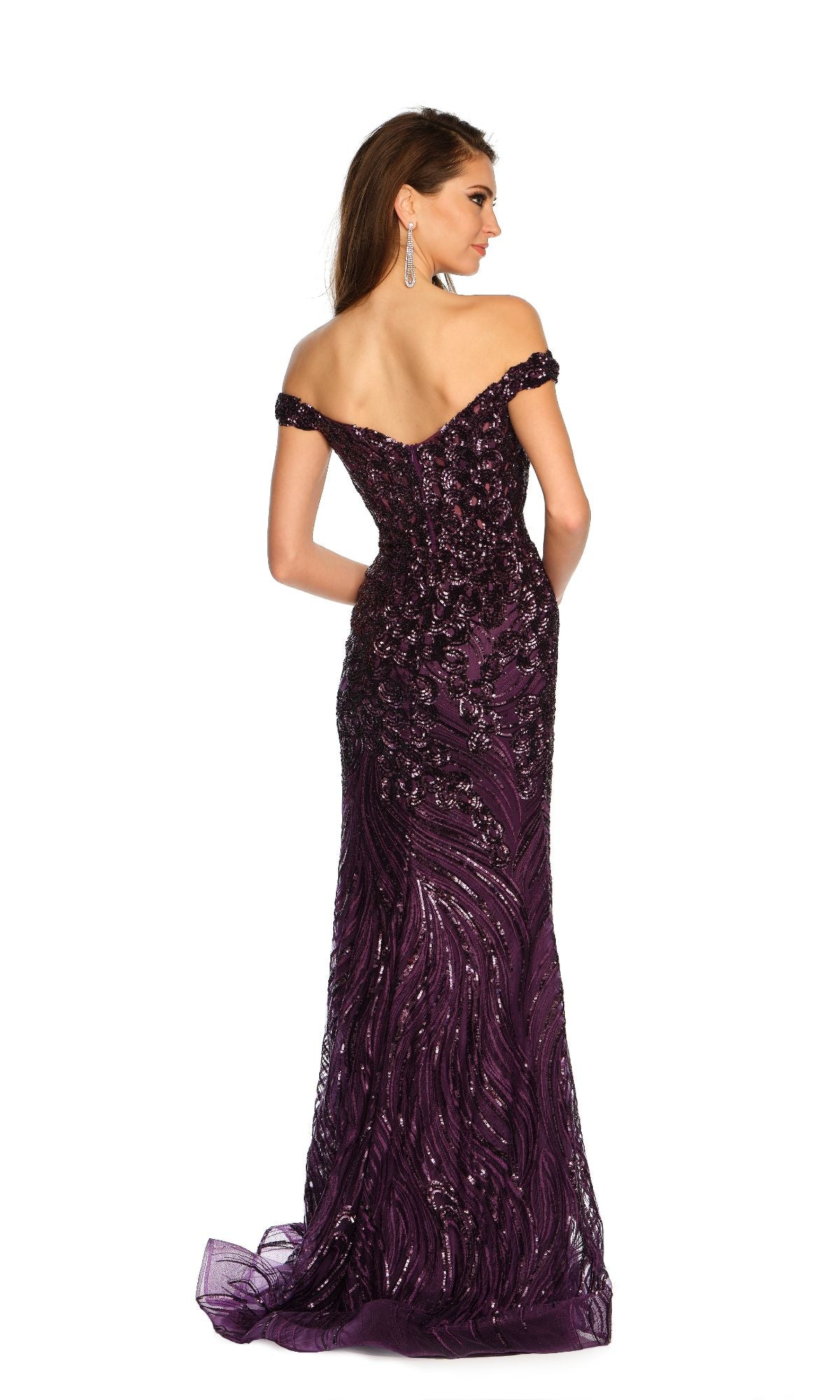 A woman with straight brown hair and drop earrings, facing away against a white background, wears the Dave and Johnny Long Purple Prom Dress 11002—an off-the-shoulder, floor-length sequin gown.
